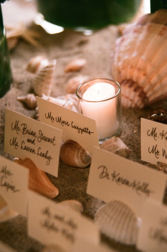 Seashell Escort Card Stands
Photography: frame.thirty.six photography
Read More:
http://www.insideweddings.com/weddings/tropical-inspired-spring-wedding-at-the-bel-air-bay-club/236/ Candlelit place cards on top of sea shells