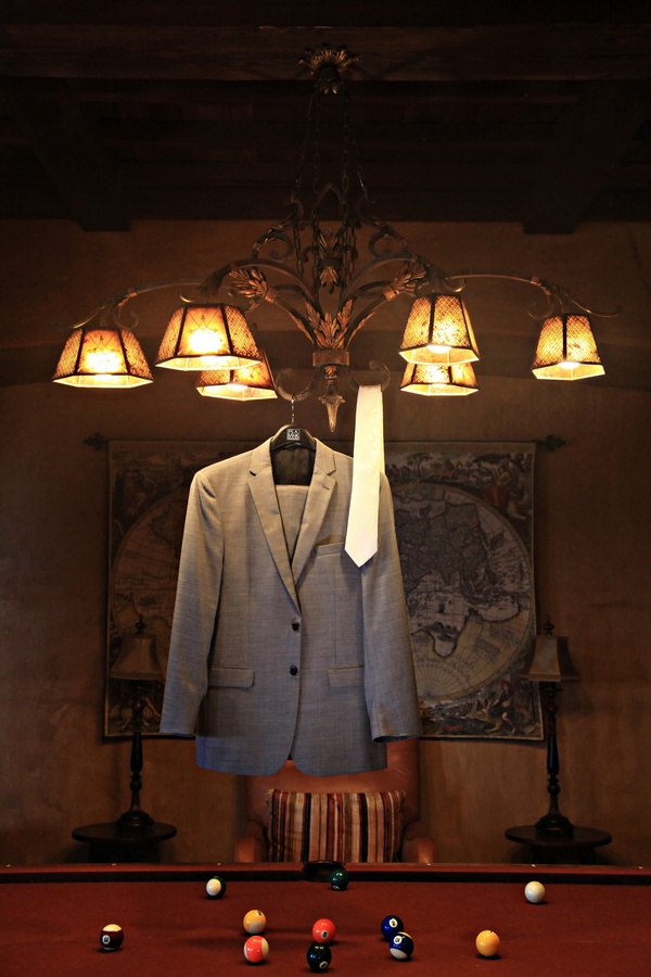 Grey Tuxedo And White Tie Hanging Over Pool Table Grey Tuxedo And White Tie Hanging Over Pool Table