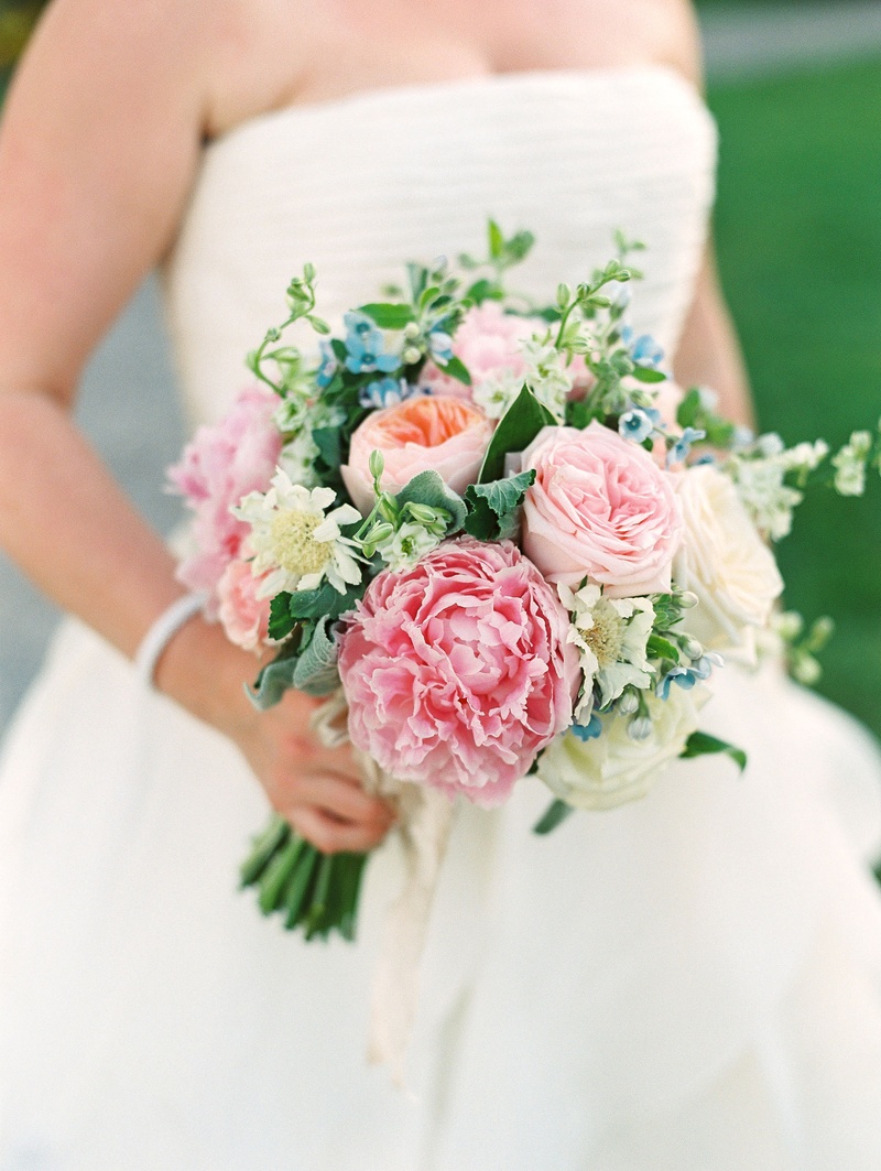 Summer Bouquet for Alfresco Ceremony
Photography: Bonnie Sen Photography
Read More:
http://www.insideweddings.com/weddings/outdoor-ceremony-tented-reception-by-a-tranquil-river-in-maryland/1088/ Bride in strapless wedding dress holding bouquet pink peony garden rose peach blue flower greenery