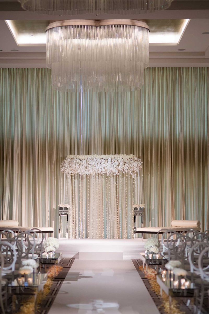 White Flowers at City-Style Ceremony
Photography: Studio This Is
Read More:
http://www.insideweddings.com/weddings/glamorous-city-style-real-wedding-at-a-luxury-hotel-in-chicago/1217/ wedding ceremony chicago ballroom chandelier white flower round back chair and flower petals aisle