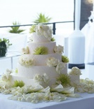 White Wedding Cake
Photography: Dalal Photography
Read More:
http://www.insideweddings.com/weddings/movie-themed-wedding-with-pops-of-green/345/ Five layer white basket weave cake with roses and green protea