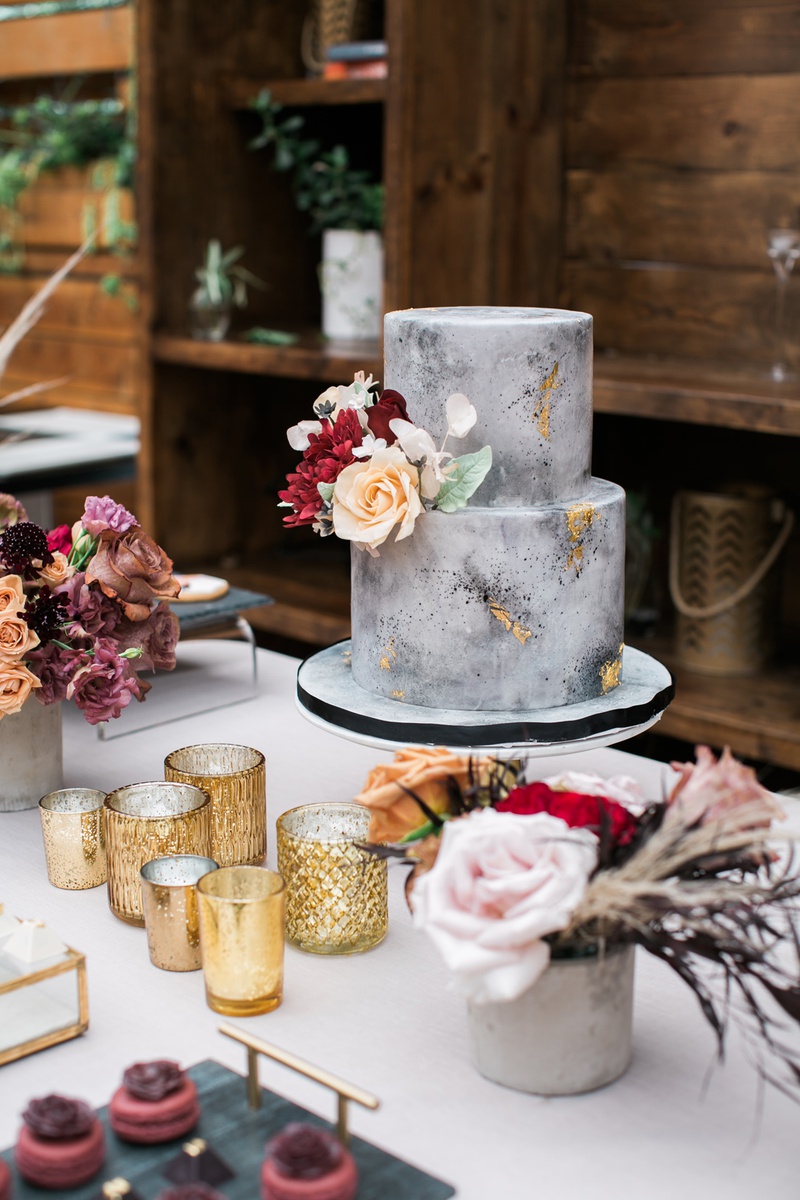 Concrete-Inspired Bridal Shower Cake
Photography: Jessica Claire Photography
Read More:
http://www.insideweddings.com/weddings/unique-chic-bridal-shower-with-dark-and-moody-color-scheme/1335/ small two-tier grey marble cake made to look like concrete with gold foil and fresh flowers