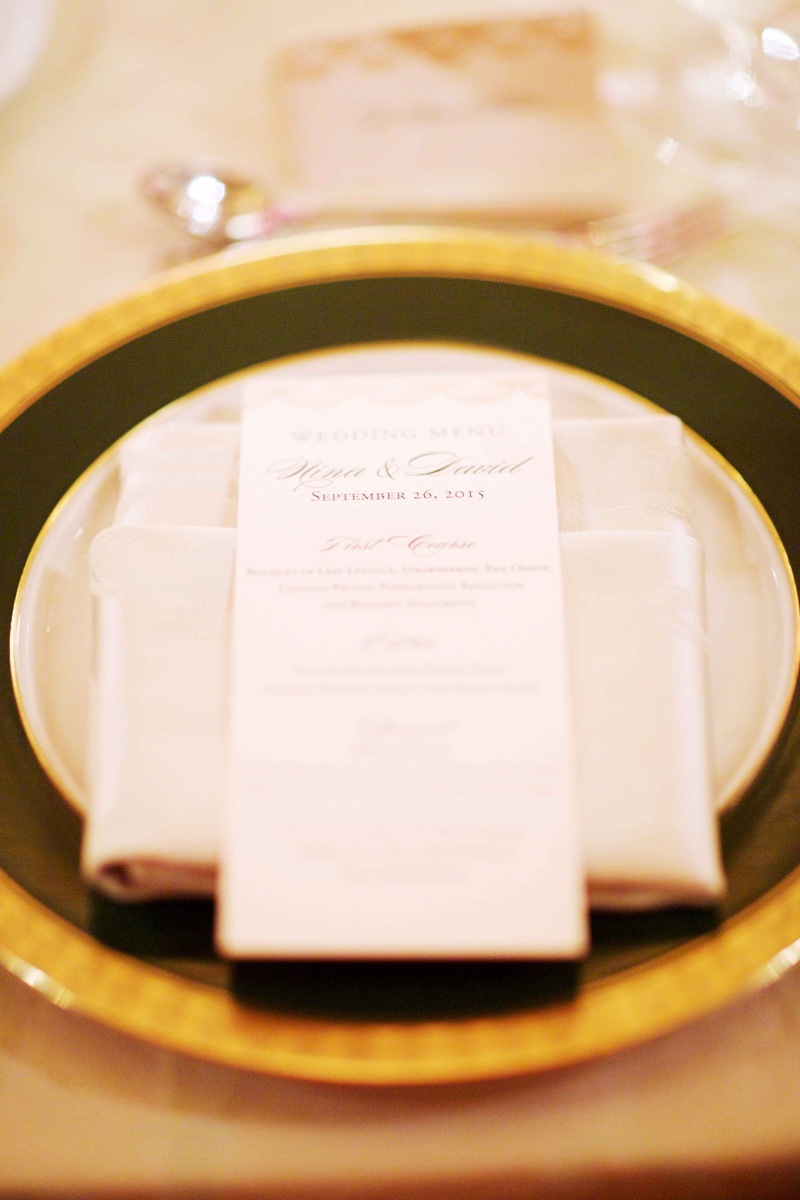 Place Setting with Gilt-Rimmed Charger
Photography: Amanda Sudimack for Artisan Events
Read More:
http://www.insideweddings.com/weddings/customized-chicago-wedding-with-pink-blush-marsala-color-palette/911/ Wedding reception place setting gold rim charger plate dinner menu on top of napkin with calligraphy