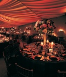 Reception Table Decor
Photography: Jay Lawrence Goldman Photography
Read More:
http://www.insideweddings.com/weddings/a-sophisticated-tented-estate-wedding-in-california/179/ Wedding reception table decorated with a tall arrangement of red, purple, green, and white flowers