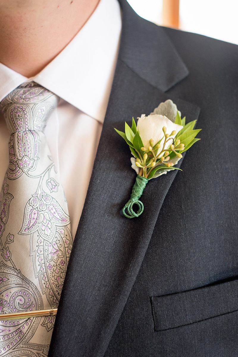 Rustic White %26 Green Boutonniere
Photography: Stacy Newgent
Read More:
http://www.insideweddings.com/weddings/rustic-barn-wedding-tented-reception-on-family-farm-in-ohio/690/ Lamb's ear, white rose, green leaf boutonniere and paisley tie