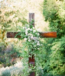 Wooden Cross Adorned with Verdure
Photography: Simply Splendid
Read More:
http://www.insideweddings.com/weddings/los-angeles-rams-nfl-player-brandin-cooks-backyard-wedding/1281/ la rams brandin cooks briannon lepman wedding, ceremony altar wooden cross greenery with some flower