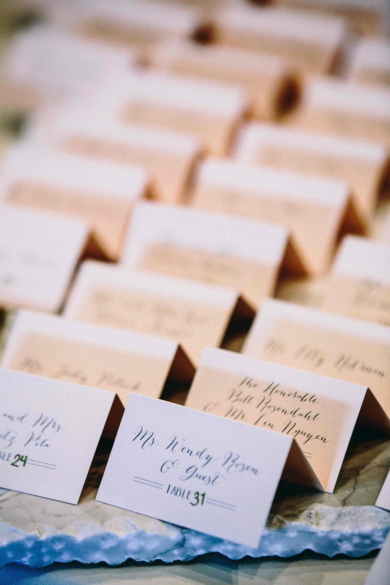 Small White Folded Escort Cards
Photography: Callaway Gable
Read More:
http://www.insideweddings.com/weddings/alfresco-summer-wedding-with-lush-foliage-accents-in-california/805/ small white folded escort cards featuring calligraphy