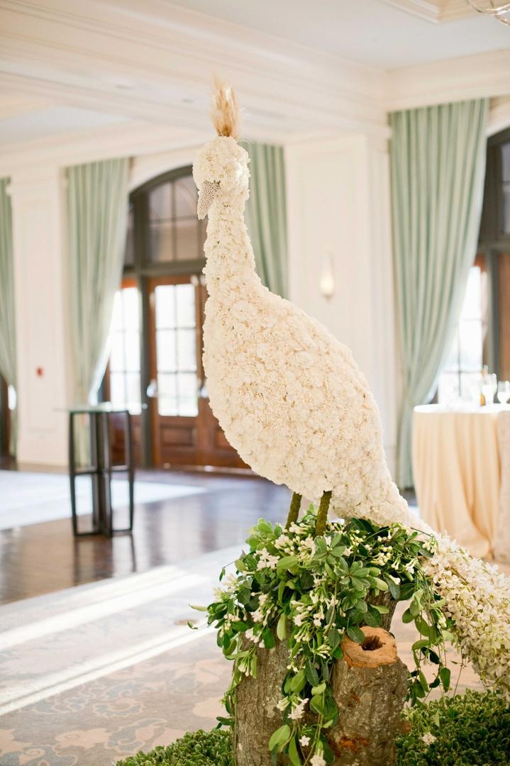Floral-Embellished Bird
Photography: Harwell Photography
Read More:
http://www.insideweddings.com/weddings/romantic-woodland-inspired-atlanta-wedding-with-natural-details/433/ Tree trunk with greenery and bird sculpture made of flowers