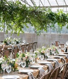 Greenery Over Reclaimed Wood Tables
Photography: Maya Myers Photography
Read More:
http://www.insideweddings.com/weddings/ocean-view-ceremony-rustic-chic-reception-in-former-greenhouse/1297/ wedding reception wood table industrial chairs low centerpiece overhead greenery greenhouse venue