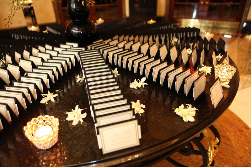 Place Card Table
Photography: Josh Lynn Photography
Read More:
http://www.insideweddings.com/weddings/purple-white-gold-new-jersey-celebration/339/ Wedding place card table with black and white cards, white flowers, and candles