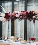 Arrangement of Moody Florals
Photography: Jessica Claire Photography
Read More:
http://www.insideweddings.com/weddings/unique-chic-bridal-shower-with-dark-and-moody-color-scheme/1335/ burgundy, red, mauve roses with pampas grass on gold stand