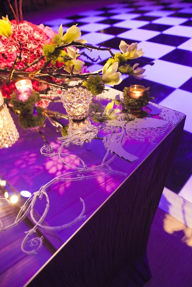Etched-Glass Tabletop
Photography: Images by Berit, Inc.
Read More:
http://www.insideweddings.com/weddings/contemporary-ballroom-wedding-with-pops-of-purple/408/ Mirror reception table with etched pattern and mossy candles