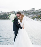 Bride %26 Groom on Bay in San Diego
Photography: Luke %26 Katherine Griffin for Max %26 Friends
Read More:
http://www.insideweddings.com/weddings/tent-wedding-with-chic-nautical-theme-on-la-playa-bay-in-san-diego/737/ Bride in white wedding dress and groom in tuxedo embrace on pier in San Diego