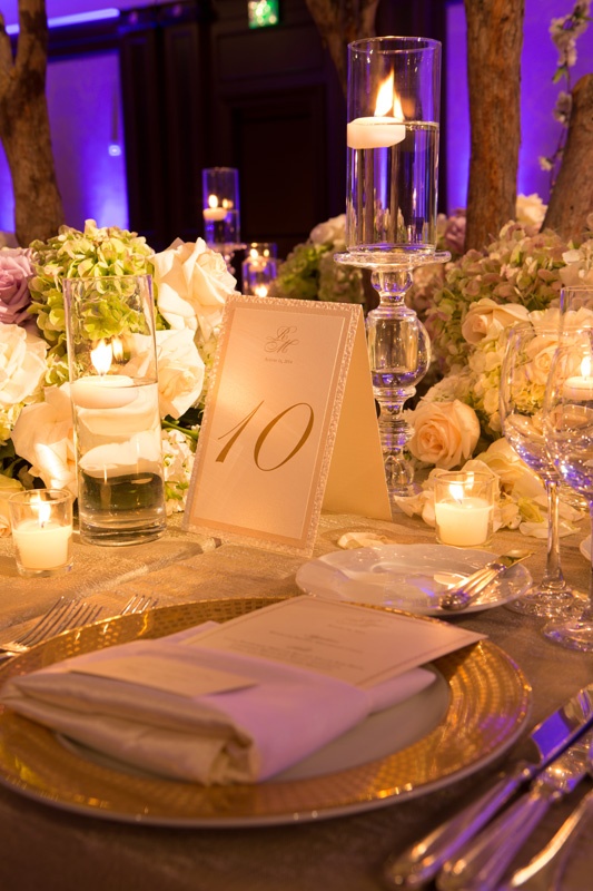 Golden Table Number at Ballroom Wedding
Photography: Jay Lawrence Goldman Photography
Read More:
http://www.insideweddings.com/weddings/elegant-white-lavender-ballroom-wedding-with-cherry-blossom-trees/710/ Wedding reception table number with monogram, glittery gold border, candles, green hydrangeas, white