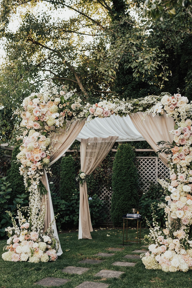 Neutral-Tone Florals Embellishing Chuppah
Photography: Sam %26 Sola Lee Photography
Read More:
http://www.insideweddings.com/weddings/modern-outdoor-ceremony-tent-reception-in-seattle-on-puget-sound/1309/ wedding ceremony structure chuppah champagne drapery white pink peach orange rose hydrangea flowers