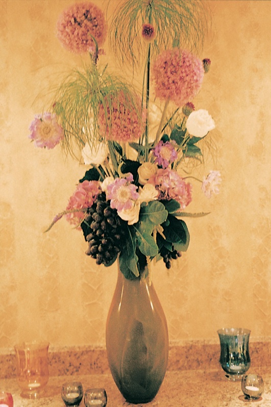 Tall Flower Arrangement
Photography: Tina Carlone Photography
Read More:
http://www.insideweddings.com/weddings/mediterranean-inspired-newport-beach-wedding/39/ Tall flower centerpiece with grapes and pink flowers
