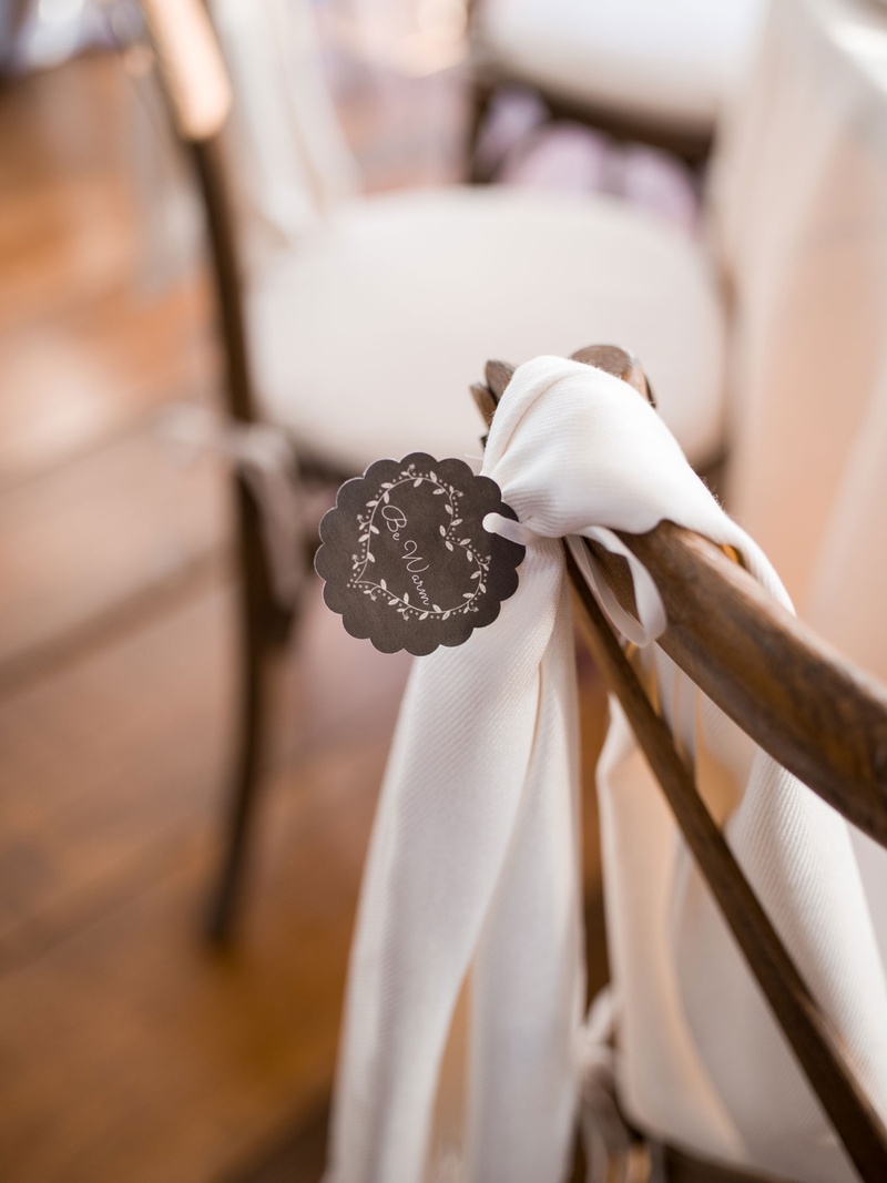 Pashmina with "Stay Warm" Tag
Photography: Eric Kelley
Read More:
http://www.insideweddings.com/weddings/chapel-ceremony-tented-reception-in-the-south-carolina-lowcountry/1057/ Wedding reception favor pashmina shawl on back of x back wood chair with stay warm tag scallop