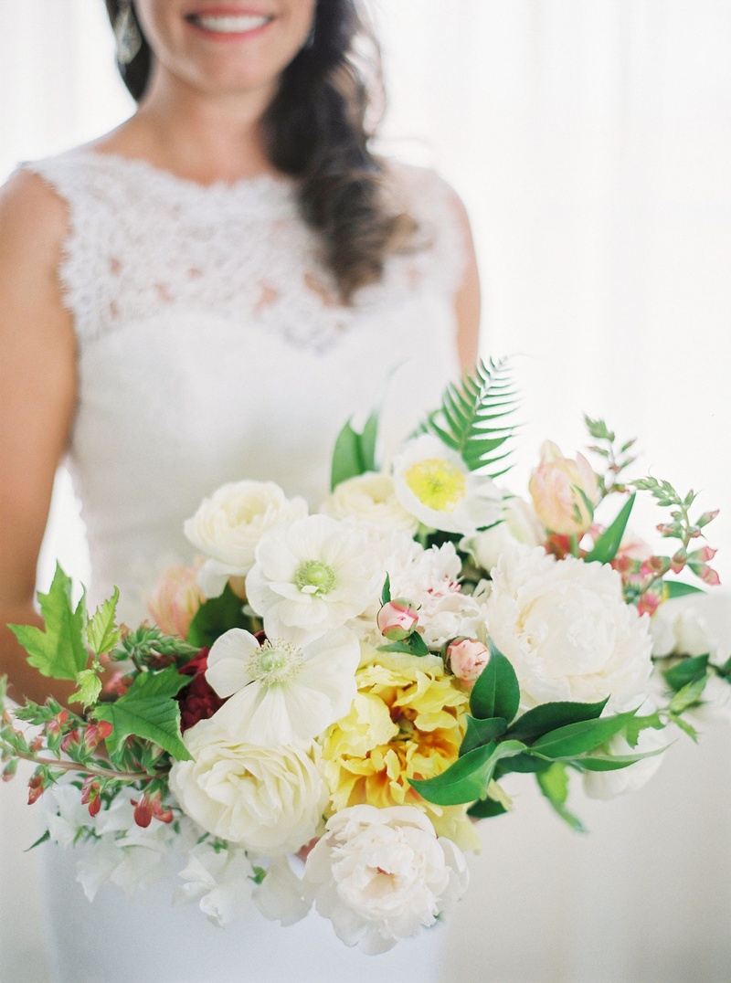 Sunny Bouquet with Ivory %26 Yellow Flowers
Photography: Branco Prata
Read More:
http://www.insideweddings.com/weddings/chic-destination-wedding-with-california-style-in-washington-dc/1042/ Bride in lace wedding dress holding bouquet of white flowers yellow flowers ferns greenery