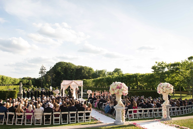 Column Risers with Hydrangea Arrangements
Photography: Brett Matthews Photography
Read More:
http://www.insideweddings.com/weddings/regal-outdoor-ceremony-ballroom-reception-at-oheka-castle-in-ny/821/ Wedding ceremony at Oheka Castle with white and pink flower arrangements, pink rose petals aisle