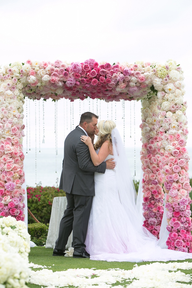 Bride %26 Groom Kiss at Chuppah
Photography: Marianne Lozano Photography
Read More:
http://www.insideweddings.com/weddings/pink-white-wedding-with-ombre-details-at-montage-laguna-beach/686/ Bride in pink ombre dress kisses groom in grey suit