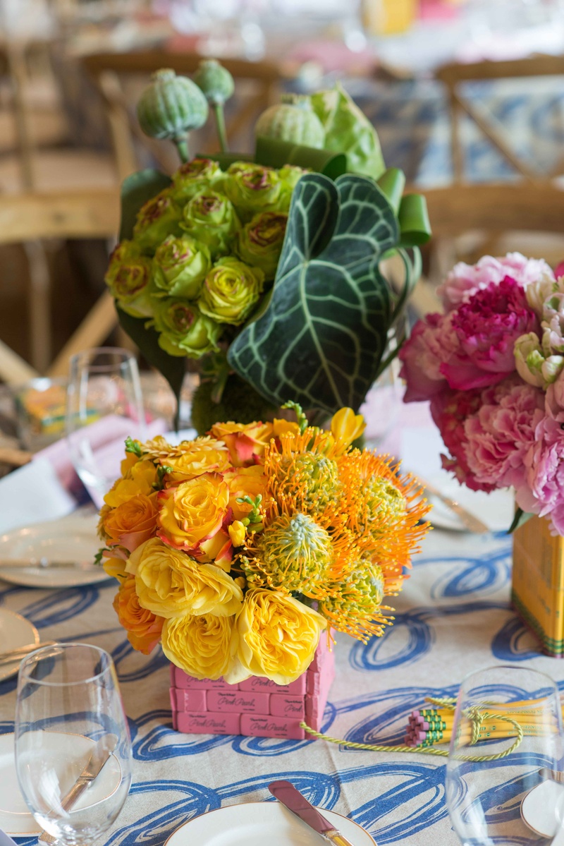 Pink Eraser Vase with Yellow Flowers
Photography: John %26 Joseph Photography Inc.
Read More:
http://www.insideweddings.com/weddings/a-school-themed-bridal-shower-in-beverly-hills-for-a-teacher/890/ Yellow flowers protea roses in pink eraser vase on table with cursive blue and white linen