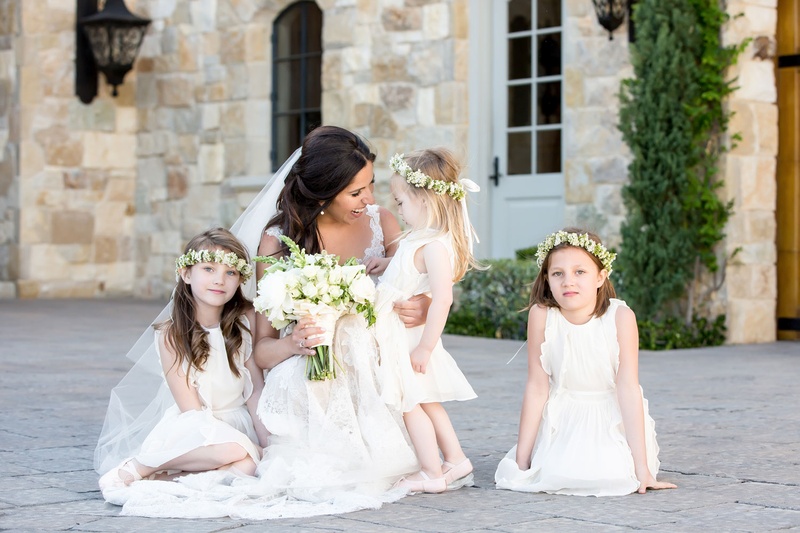 Bride with Flower Girls in White
Photography: Maya Myers Photography
Read More:
http://www.insideweddings.com/weddings/malibu-wedding-with-gorgeous-views-of-the-santa-monica-mountains/974/ Bride in Monique Lhuillier wedding dress holding bouquet with three flower girls in flower crowns