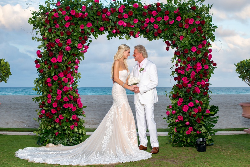 Bride %26 Groom at Acqualina Resort %26 Spa
Photography: Suzanne Delawar Studios
Read More:
http://www.insideweddings.com/weddings/intimate-oceanfront-wedding-with-romantic-red-pink-white-palette/1235/ bride in strapless wedding dress with groom in white suit pink shirt under greenery arch pink roses