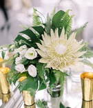 Tropical Fern %26 Protea Centerpiece
Photography: Lauren Gabrielle Photography
Read More:
http://www.insideweddings.com/weddings/summer-real-wedding-featuring-tropical-decor-at-an-art-museum/1328/ low wedding centerpiece king protea white flower monstera leaf fern gold candle votives tropical