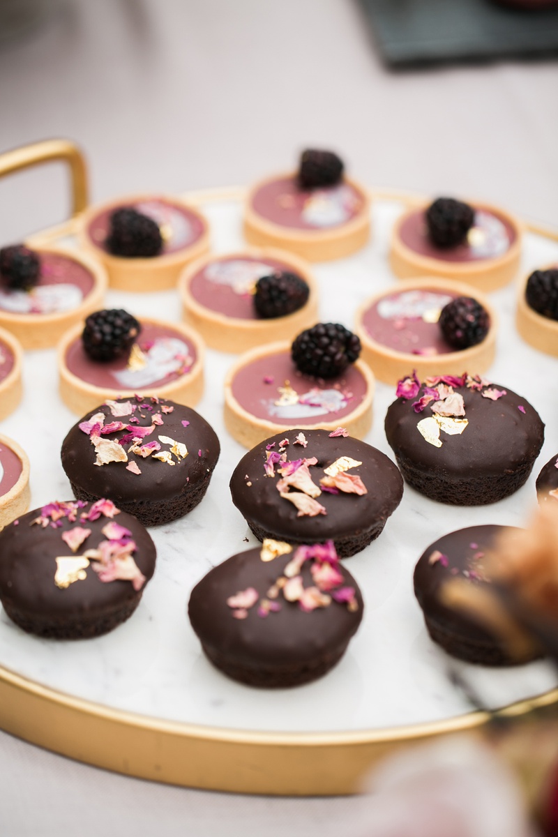 Delicate Desserts
Photography: Jessica Claire Photography
Read More:
http://www.insideweddings.com/weddings/unique-chic-bridal-shower-with-dark-and-moody-color-scheme/1335/ small chocolates with magenta white chocolate shavings, blackberry fruit tart