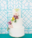 Three-Layer Smooth Wedding Cake
Photography: Kir2Ben Photography
Read More:
http://www.insideweddings.com/weddings/a-millennial-bloggers-festive-post-wedding-styled-shoot-in-florida/994/ White fondant wedding cake three layer cascading fresh flowers yellow purple pink green paint