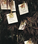 Place Cards Hanging in Tree
Photography: Katherine Lasford
Read More:
http://www.insideweddings.com/weddings/victorian-theme-home-wedding-in-vancouver-british-columbia/119/ Flower motif wedding place cards hanging from tree