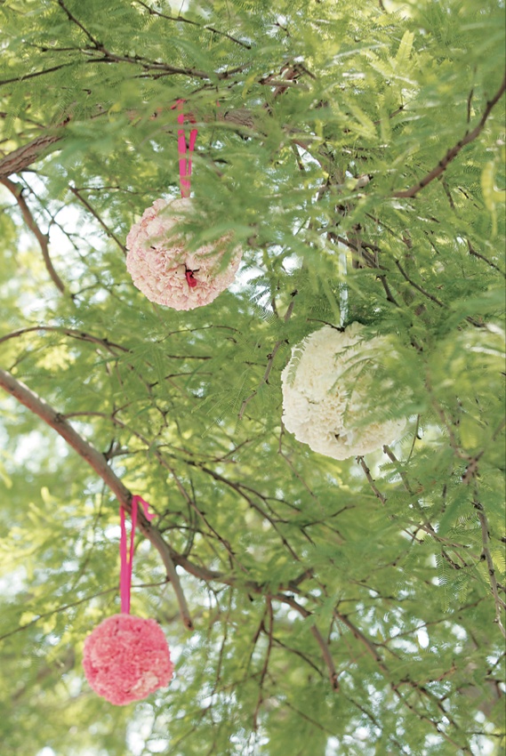 Pomander Balls
Photography: Asgeir Bollason for David Michael Photography
Read More:
http://www.insideweddings.com/weddings/pink-green-memorial-day-weekend-wedding-in-palm-desert/128/ Ball of flowers and ribbon hanging from tree
