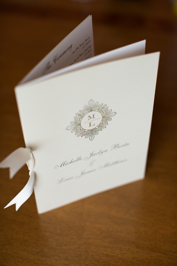 Elegant Ceremony Program
Photography: Aaron Watson Photography
Read More:
http://www.insideweddings.com/weddings/classic-virginia-wedding-inspired-by-grace-kellys-elegance/511/ White bow tied to wedding program with monogram