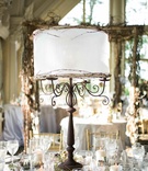 Rustic Lamp Centerpiece
Photography: Images by Berit, Inc.
Read More:
http://www.insideweddings.com/weddings/east-coast-countryside-wedding-with-vintage-details/521/ Iron candelabra centerpiece with white lamp shade and branches