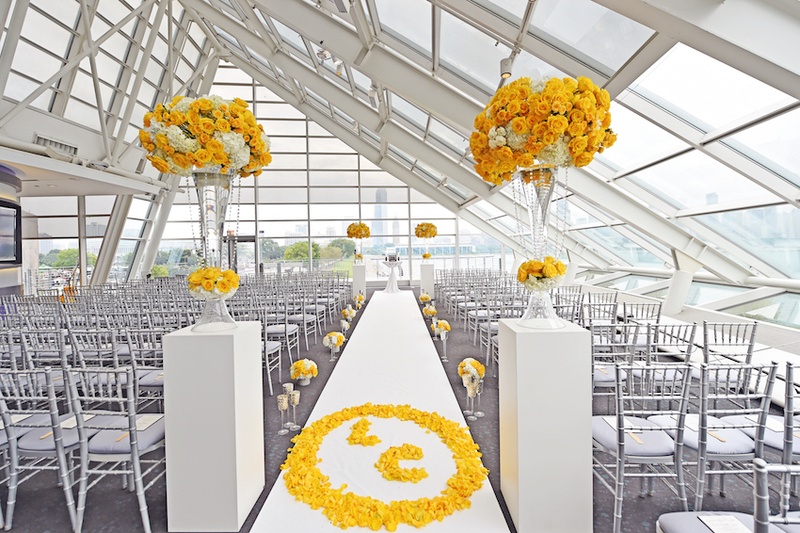 Aisle Runner with Yellow Monogram
Photography: Carasco Photography
Read More:
http://www.insideweddings.com/weddings/city-wedding-at-chicago-planetarium-with-purple-yellow-palette/688/ Wedding ceremony at the Adler Planetarium with bride and groom's monogram in yellow rose petals