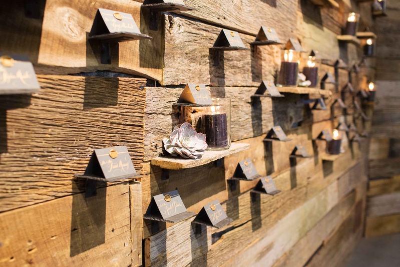 Escort Card Wood Display
Photography: Perez Photography
Read More:
http://www.insideweddings.com/weddings/incredible-tented-ceremony-barn-reception-at-ranch-in-aspen/860/ Rustic wood wall with shelves, succulents, candles, escort cards with wax seals