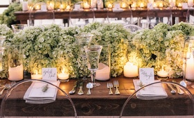 Candlelit Dinner Table
Photography: Vue Photography
Read More:
http://www.insideweddings.com/weddings/southern-lake-house-wedding-with-ivory-and-green-color-palette/534/ Ghost chairs around wood table with candles