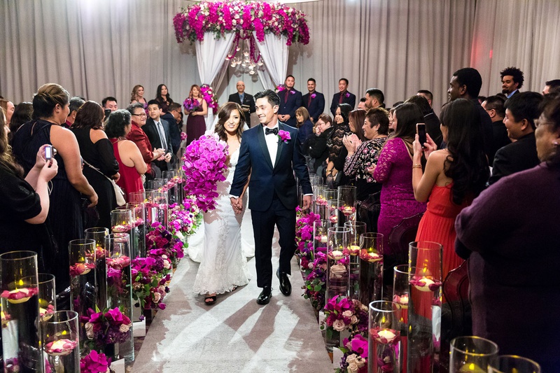 Cheerful Recessional
Photography: Brian Leahy Photography
Read More:
http://www.insideweddings.com/weddings/a-hawaiian-couples-luxurious-destination-wedding-in-las-vegas/1226/ asian bride and groom wedding inspiration, fuchsia orchids, purple orchids, guests taking photos