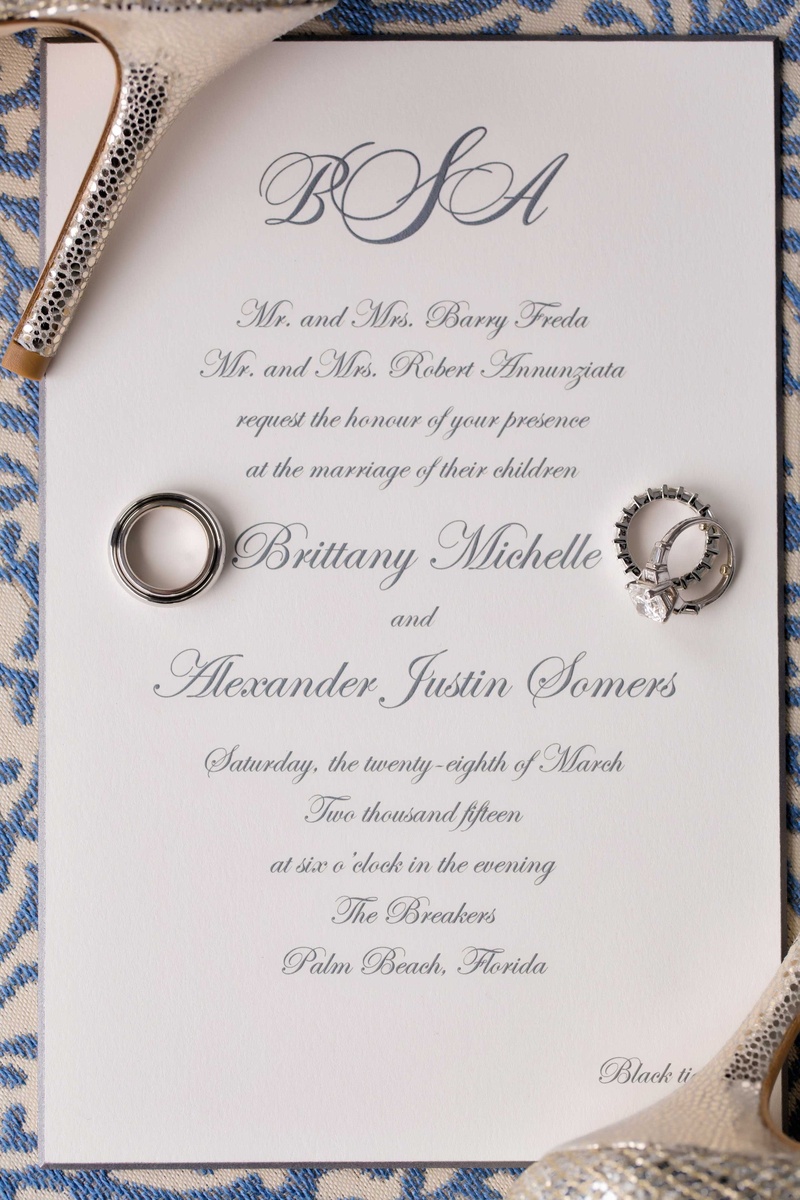 Grey Monogram Wedding Invite
Photography: Muñoz Photography
Read More:
http://www.insideweddings.com/weddings/colorful-jewish-ceremony-ballroom-reception-at-the-breakers/818/ White black tie wedding invitation with grey calligraphy and monogram at top wedding rings resting