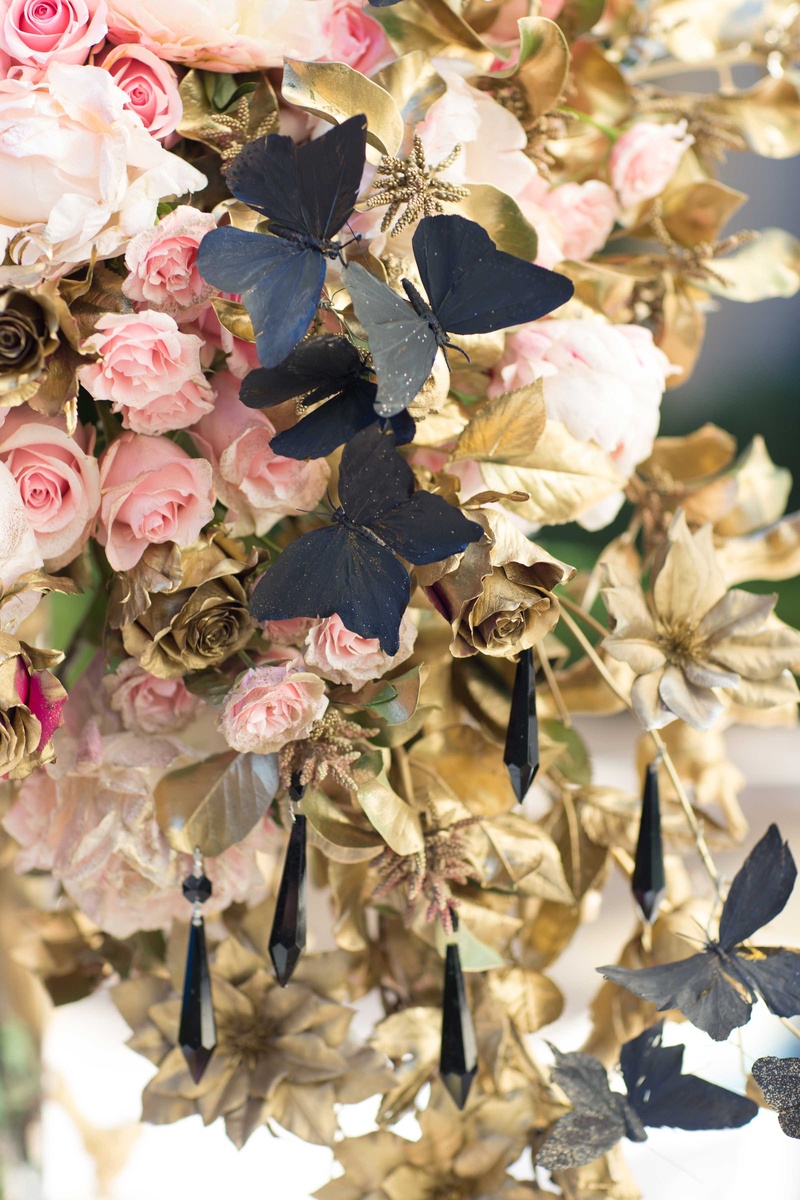 Centerpiece with Pink Roses and Black Butterflies
Photography: Thisbe Grace Photography
Read More:
http://www.insideweddings.com/weddings/dramatic-wedding-shoot-inspired-by-alexander-mcqueen-chanel/749/ large floral centerpiece alexander mcqueen chanel pink roses black butterflies hanging jewels