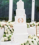 White Cake with Laurel Leaf Crest
Photography: Robert Evans Studios
Read More:
http://www.insideweddings.com/weddings/traditional-catholic-ceremony-romantic-tented-at-home-reception/664/ White wedding cake with sugar roses, vines, and couple's monogram crest in gold