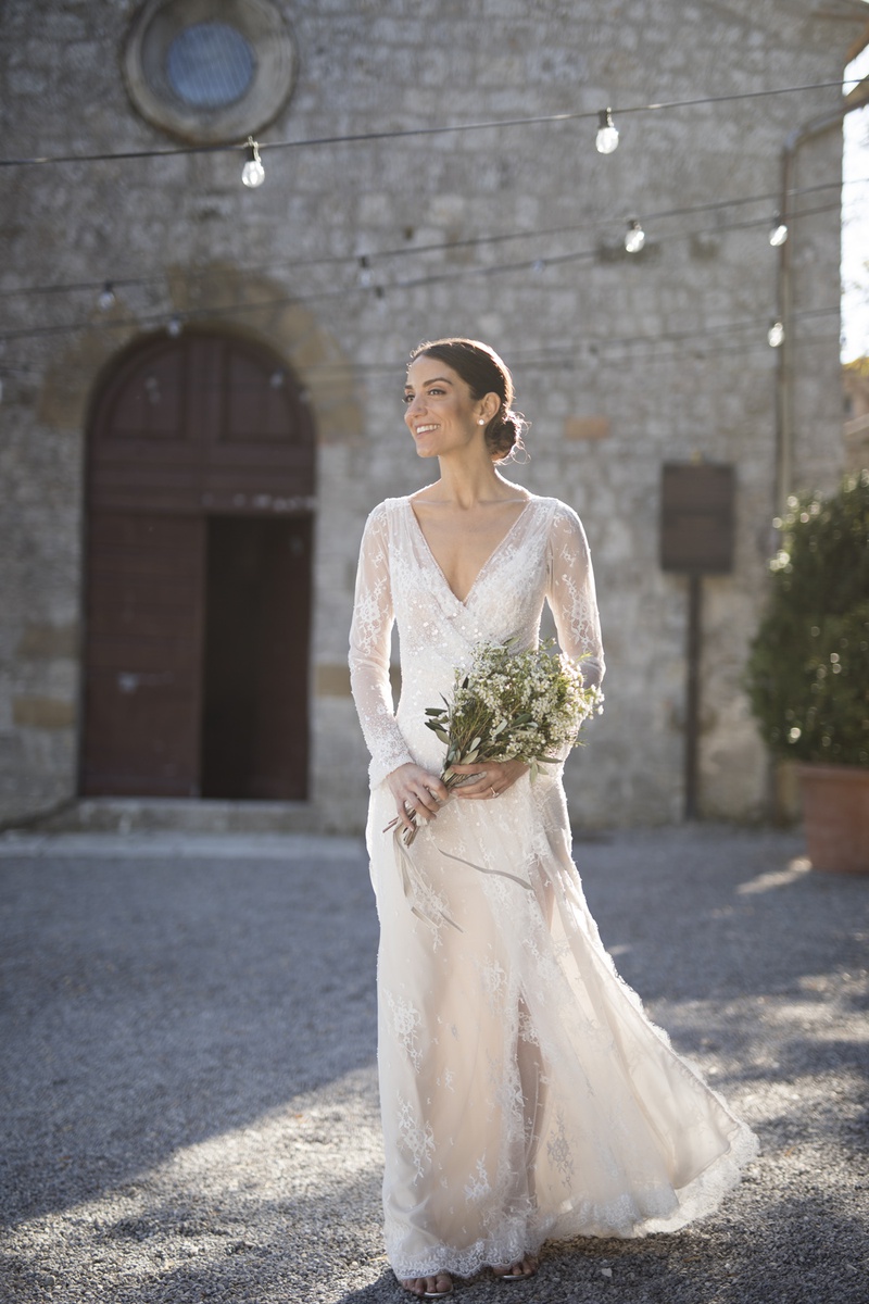 Bride in Tuscan Courtyard
Photography: The Day by Ira Lippke
Read More:
http://www.insideweddings.com/weddings/romantic-ceremony-on-bluff-tented-reception-in-tuscany/1311/ bride in inbal dror lace wrap dress with v neck and long sleeves in tuscany courtyard