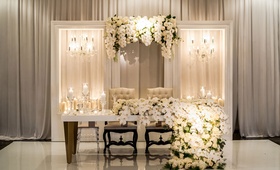 Extravagant Sweetheart Table
Photography: Lilly Photography
Read More:
http://www.insideweddings.com/weddings/traditional-greek-orthodox-ceremony-ballroom-reception-in-chicago/1105/ lacquer sweetheart table with two chandeliers on both sides candles tall candleholders orchid