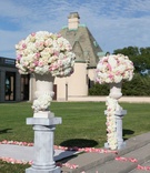 Ceremony Entrance with Flower Arrangements
Photography: Brett Matthews Photography
Read More:
http://www.insideweddings.com/weddings/regal-outdoor-ceremony-ballroom-reception-at-oheka-castle-in-ny/821/ White hydrangea pink rose flower arrangement on column riser aisle with pink flower petals