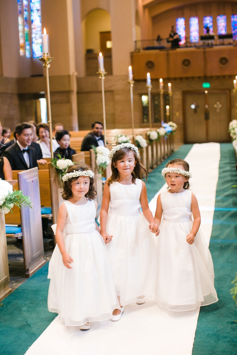 Church Flower Girls Holding Hands
Photography: Michelle Beller Photography
Read More:
http://www.insideweddings.com/weddings/classic-ceremony-beachfront-ballroom-reception-in-santa-monica/1234/ three flower girls in white dresses white flower crowns holding hands down aisle white runner