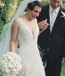 Vintage-Inspired Wedding Dress
Photography: Lara Porzak Photography
Read More:
http://www.insideweddings.com/weddings/vintage-art-deco-style-poolside-wedding-in-beverly-hills/106/ Low cut ivory lace wedding dress with feathers