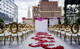 Rooftop Ceremony in New York City
Photography: Amy Anaiz Photography
Read More:
http://www.insideweddings.com/weddings/rooftop-ceremony-glam-reception-with-chic-blooms-in-new-york-city/1019/ Gold chairs white cushions flower petal swirl aisle runner white drape altar brick skyline empire