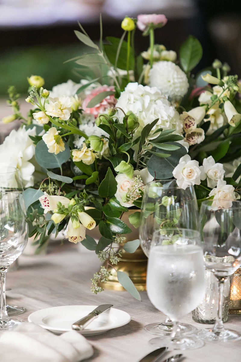 Wedding Centerpiece in Gold Vessel
Photography: Vue Photography
Read More:
http://www.insideweddings.com/weddings/destination-rustic-fall-wedding-at-a-farm-in-north-carolina/1202/ wedding reception low centerpiece gold footed vase white hydrangea rose pink dahlia flowers