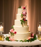 Classic Five Layer Wedding Cake
Photography: Jay Lawrence Goldman Photography
Read More:
http://www.insideweddings.com/weddings/outdoor-ceremony-ballroom-reception-with-pink-flowers-greenery/1135/ Wedding cake with five ivory layer tier with candles pink flowers green leaves greenery