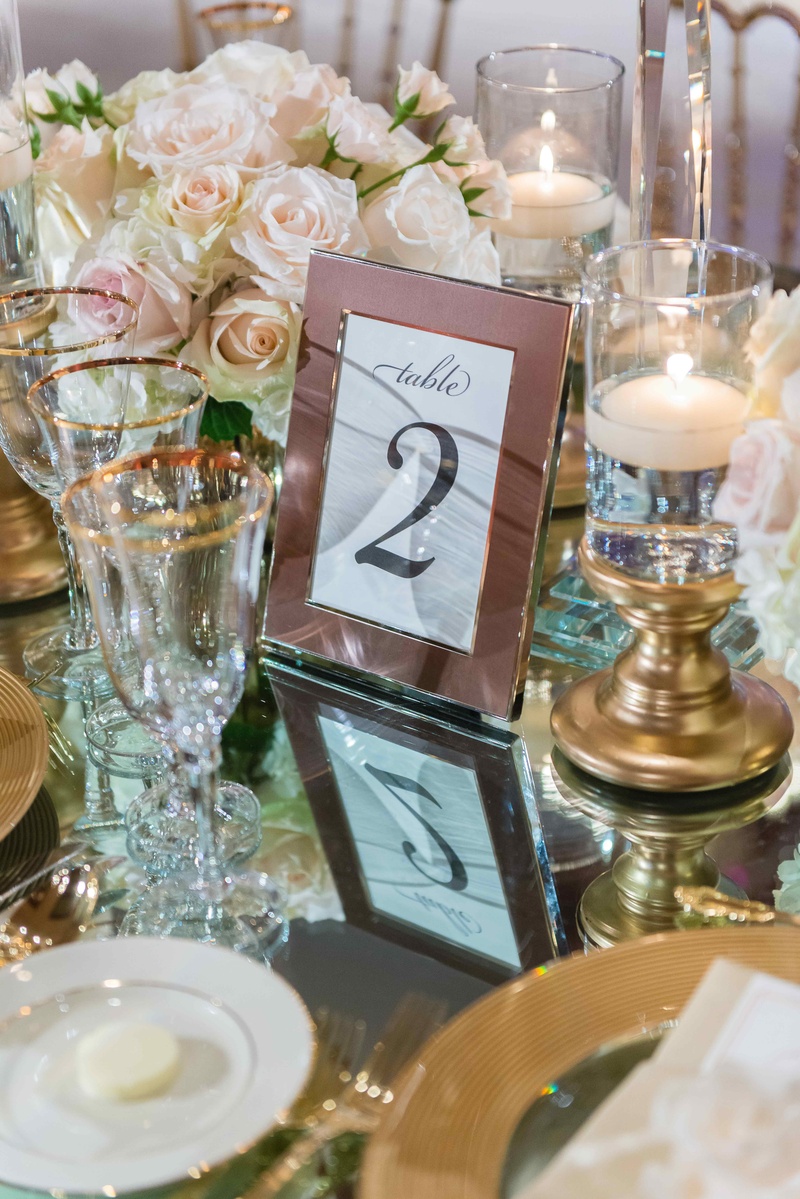 Mirror Table with Framed Table Number
Photography: The Yodsukars
Read More:
http://www.insideweddings.com/weddings/glam-10th-wedding-anniversary-party-vow-renewal-in-california/917/ Framed table number on mirror reception table with gold candle holder floating candles rimmed glasse